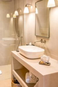 a bathroom with a white sink and a mirror at Boutique hôtel Château Rouher in Propriano