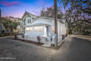 a white house on the side of a street at Steps to Trolley Stop 11 Renovated Home with Free EV Station in St. Augustine