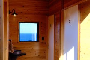 a room with a window in a wooden house at On The Cliff in Karatsu +26 photos