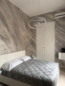 a bedroom with a large bed and a stone wall at Dimora Lanamar in Conversano +13 photos