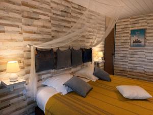 a bedroom with a large bed with a canopy at Faaora Lodge, little paradise Moorea in Haapiti