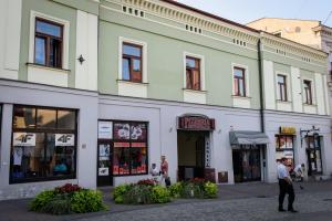 a man standing in front of a building at Apartamenty Wałowa 4 in Tarnów