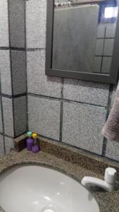 a bathroom with a sink and a mirror at Pousada Formosa in Porto Seguro +114 photos