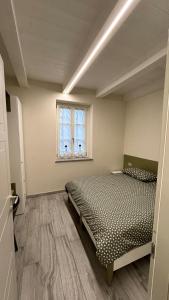 a bedroom with two beds and a window at Baratà Apartments 2 in Savigliano