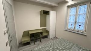 a dressing room with a desk and a window at Baratà Apartments 2 in Savigliano +4 photos
