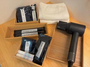 two wooden shelves with a hair dryer and a microphone at On The Cliff in Karatsu