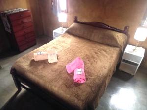 a bedroom with a bed with two bags on it at Alojamiento La Oti in Tilcara