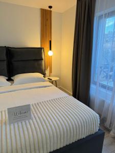 een slaapkamer met een bed met een bordje erop bij RDT Guest House-Rai din Transilvania in Moieciu de Jos