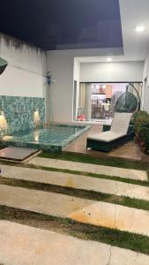 a swimming pool in a building with a pool at Casa com Piscina em Tamandaré in Tamandaré