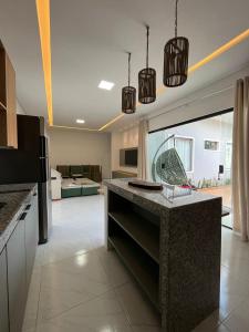 a kitchen with a island in the middle of a room at Casa com Piscina em Tamandaré in Tamandaré +15 photos