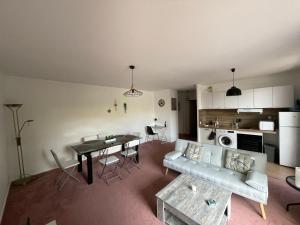 a living room with a couch and a table at Appartement Saint Genis Pouilly Cern in Saint-Genis-Pouilly