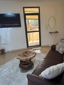 a living room with a couch and a coffee table at Maison Diop in Ziguinchor