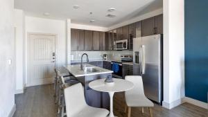 een keuken met een spoelbak en een tafel met stoelen bij Landing Stunning 2BD Courtyard Gym in Denton
