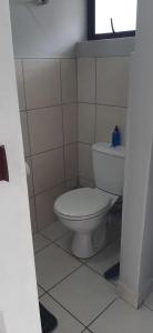 a bathroom with a white toilet and a window at Grace Villas 30 in East London