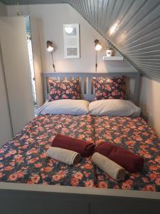 a bed with two pillows on it in a bedroom at Nárcisz Vendégház 2 in Mezőkövesd
