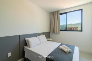 En eller flere senge i et værelse på Aptos em prédio a 90 m da praia de Perequê - RIHs