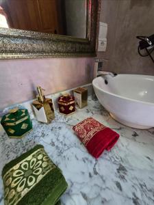 a bathroom with a sink and a towel on a counter at Chambres Émeraude et Rubis - Riad Lotus Bleu in Fès