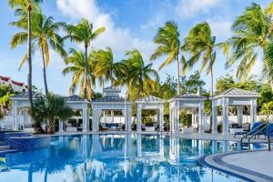 a pool with a gazebo and palm trees at DoubleTree by Hilton Grand Key Resort in Key West