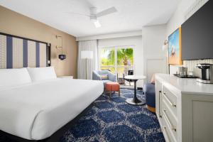 a hotel room with a large bed and a desk at DoubleTree by Hilton Grand Key Resort in Key West +56 photos