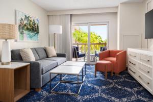 a living room with a couch and a chair at DoubleTree by Hilton Grand Key Resort in Key West