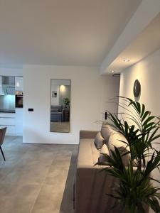 a living room with a couch and a mirror at Ferienwohnung Relax - mit Whirlpool & Sauna in Medebach