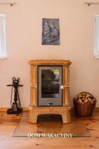 a tv sitting on a stand in a room at Domek w Dolinie Drwęcy in Lubicz