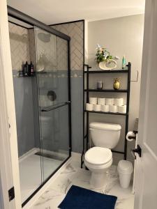 a bathroom with a shower and a toilet at Cozy boho downtown apartment in Calgary