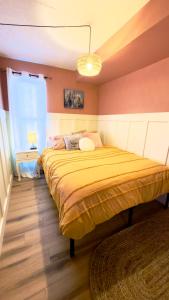 a bedroom with a large yellow bed in a room at Cozy boho downtown apartment in Calgary