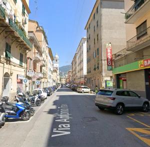 a city street with cars parked on the side of the road at Casa Orchidea in Genoa