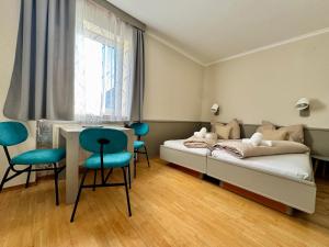 een slaapkamer met een bed, een tafel en stoelen bij Gasthaus Paus in Götzendorf an der Leitha +61 foto's