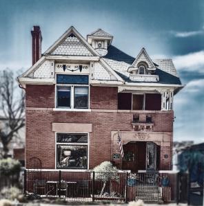 a red brick house with a flag on it at Off Broadway B & B in Denver
