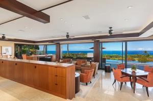 a dining room with a view of the ocean at Luxury Oceanview Villa with Infinity Pool in Hapuna Beach