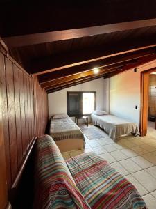 a bedroom with two beds in a room at A casa do sonho in Palhoça