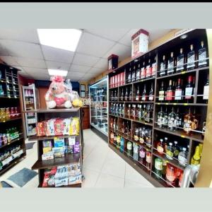 a store aisle with bottles of alcohol on display at Hospedaje secretos in Huancayo