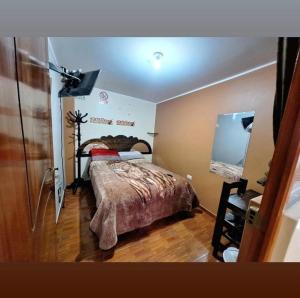 a bedroom with a bed and a dresser in it at Hospedaje secretos in Huancayo