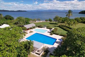 an overhead view of a swimming pool and the ocean at OPacifico Hotel Boutique in Playa Naranjo