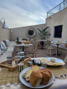 a table with plates of food on a patio at Riad Douha in Marrakesh