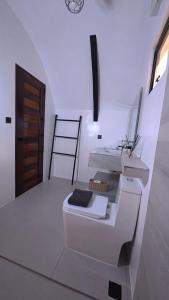 a bathroom with a toilet in a room with a ladder at Kubotique Beachfront Staycation in El Nido +51 photos