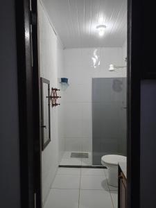a bathroom with a shower and a toilet at Moinho dos ventos in São Pedro da Aldeia +12 photos