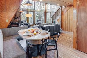 a dining room with a table and some chairs at Hot Tub & Barrel Sauna: Lakefront Innsbrook Chalet in Wright City