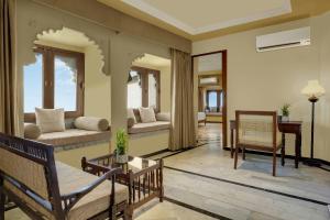 a living room with chairs and a couch and a table at The Fern Bambora Fort Udaipur, Bambora, Series by Marriott in Udaipur