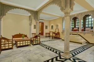 a living room with a table and a couch at The Fern Bambora Fort Udaipur, Bambora, Series by Marriott in Udaipur