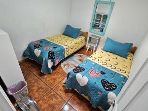a bedroom with two beds and a mirror at MatSofy_Apartamento in Santiago