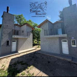 een uitzicht op een huis met twee gebouwen bij cabañas RIALTO in Villa Amancay