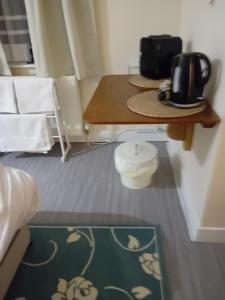 a room with a table and a table and chairs at Owls Roost in Stowmarket