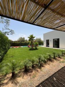 a view of the backyard of a house with palm trees at Villa soléa - Route Ouarzazate in Marrakesh
