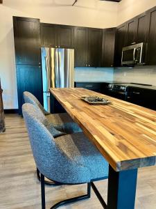 a kitchen with a wooden table and blue chairs at Brick & Bed Riverfront Lofts, T 401 in Saint Louis