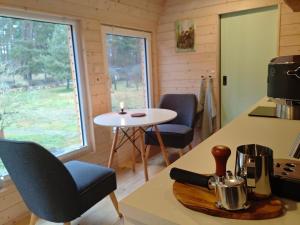 a kitchen with a table and chairs in a tiny house at Tiny House am Waldrand in Heideblick