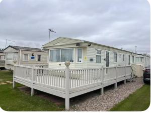 a large white mobile home with a porch at A and C Coastal Hideaway Private Decking in Colchester