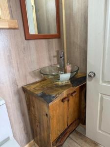 a bathroom with a glass sink on top of a wooden cabinet at Cabaña Lago Ranco in Ranco +15 photos